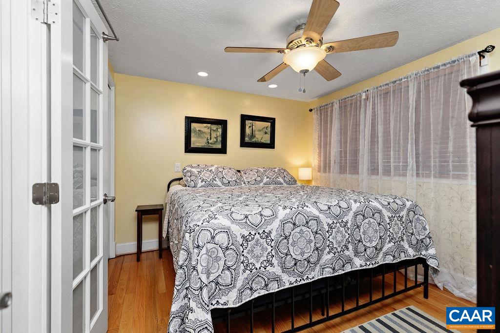 411 Three Ridges Roseland, VA 22967 - Photo 13 of 27 a bedroom with a bed and a chandelier