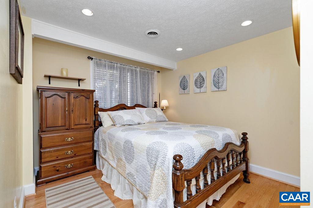 411 Three Ridges Roseland, VA 22967 - Photo 18 of 27 a bedroom with a bed and wooden floor