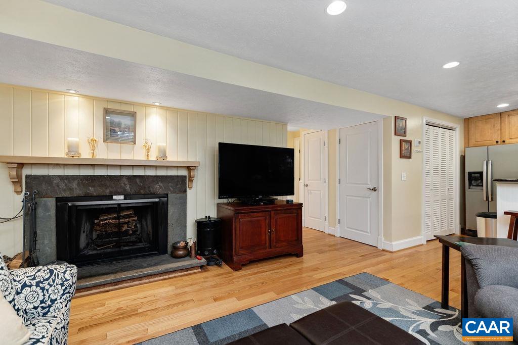 411 Three Ridges Roseland, VA 22967 - Photo 4 of 27 a living room with furniture a flat screen tv and a fireplace
