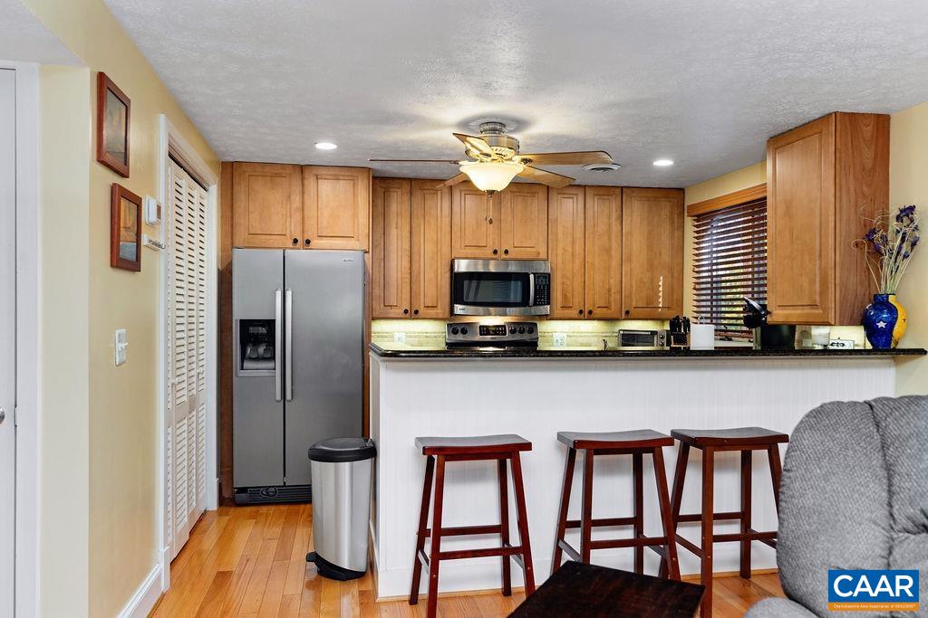 411 Three Ridges Roseland, VA 22967 - Photo 9 of 27 a kitchen with stainless steel appliances granite countertop a refrigerator a stove a sink cabinets and a dining table