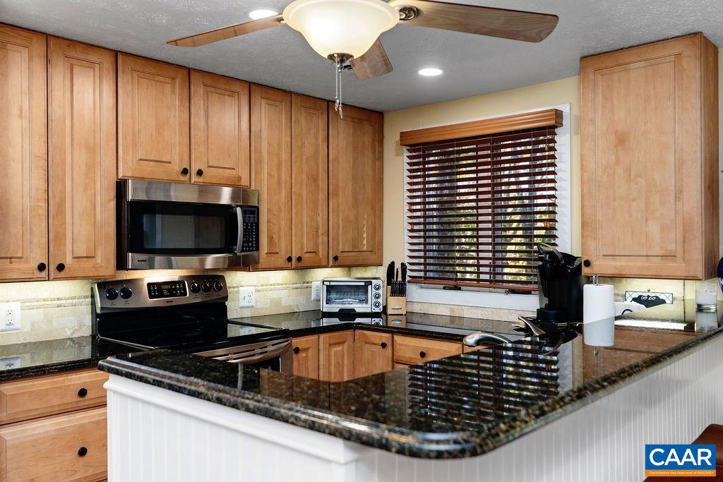 411 Three Ridges Roseland, VA 22967 - Photo 10 of 27 a kitchen with kitchen island granite countertop a sink stainless steel appliances and a counter space