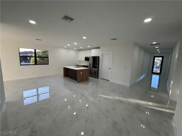 a view of a livingroom with kitchen