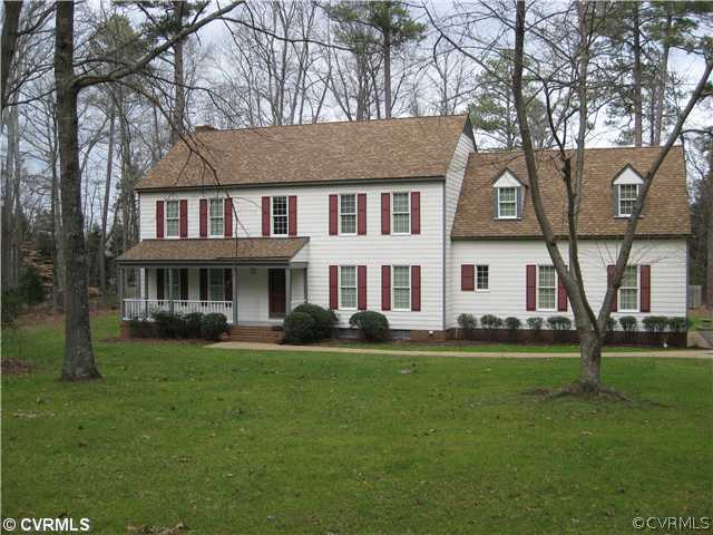 10830 Cherokee Road Midlothian, VA 23113 - Photo 2 of 17 a view of a white house with a big yard and potted plants and trees