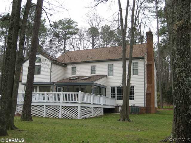 10830 Cherokee Road Midlothian, VA 23113 - Photo 3 of 17 a front view of house with yard and trees in the background