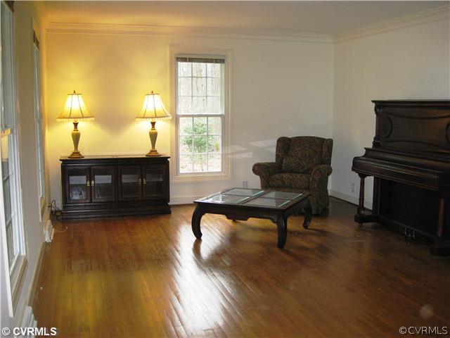 10830 Cherokee Road Midlothian, VA 23113 - Photo 8 of 17 a living room with furniture and a fireplace