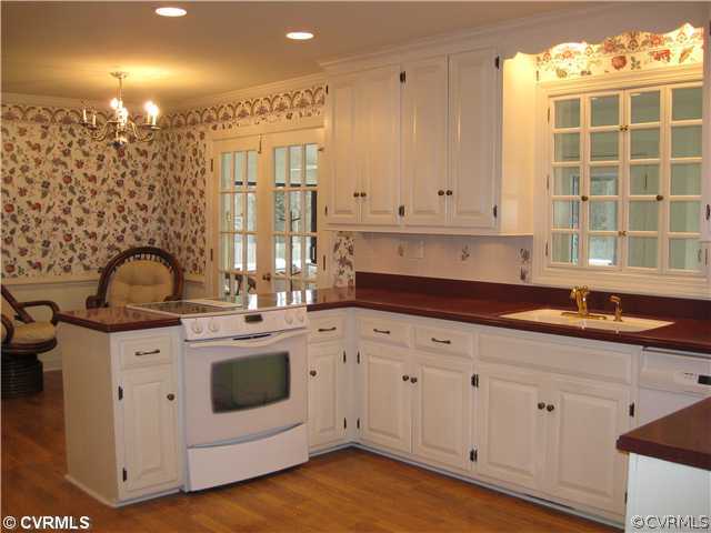 10830 Cherokee Road Midlothian, VA 23113 - Photo 9 of 17 a kitchen with granite countertop white cabinets and white appliances