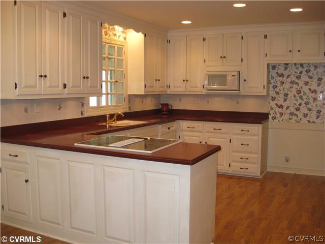 10830 Cherokee Road Midlothian, VA 23113 - Photo 10 of 17 a kitchen with stainless steel appliances granite countertop a sink and a stove