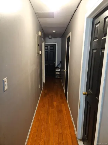 a view of hallway with wooden floor