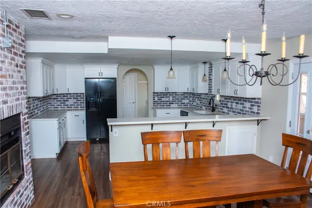 a kitchen with stainless steel appliances granite countertop a sink chairs and stove