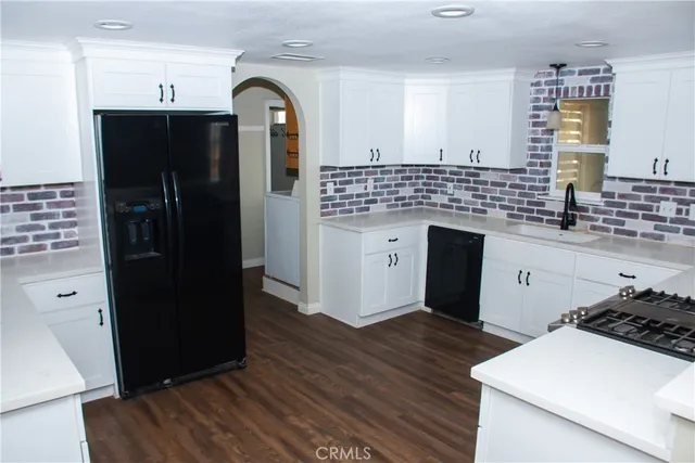 a kitchen with a refrigerator and a sink