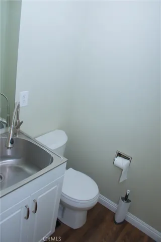a white toilet sitting next to a bathroom sink