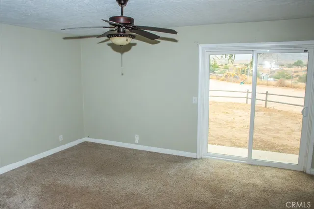 a view of room with window and ceiling fan