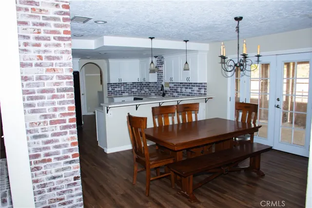 a dining room with a wooden table and chairs