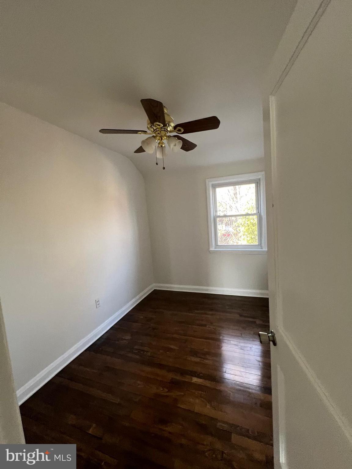 603 Braeside Road Baltimore, MD 21229 - Photo 19 of 30 a view of an empty room with wooden floor and a window