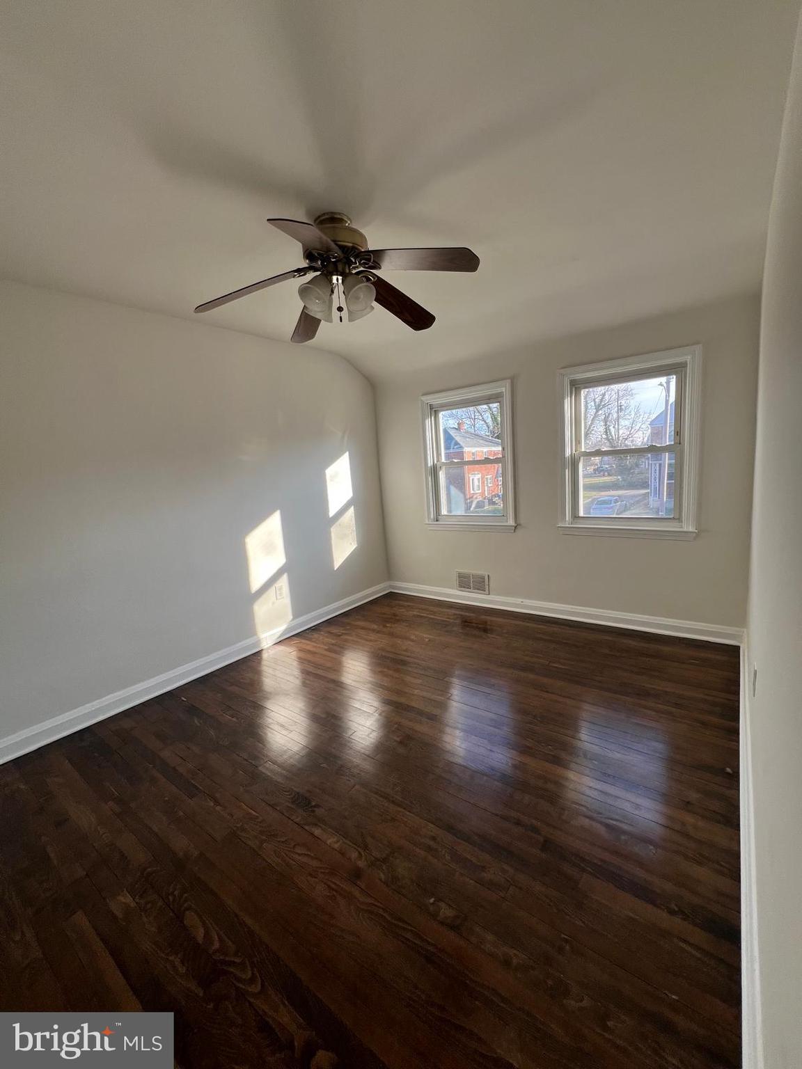 603 Braeside Road Baltimore, MD 21229 - Photo 22 of 30 a view of empty room with wooden floor and fan