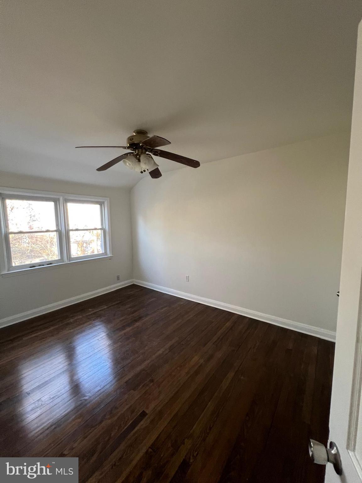 603 Braeside Road Baltimore, MD 21229 - Photo 25 of 30 an empty room with wooden floor fan and windows