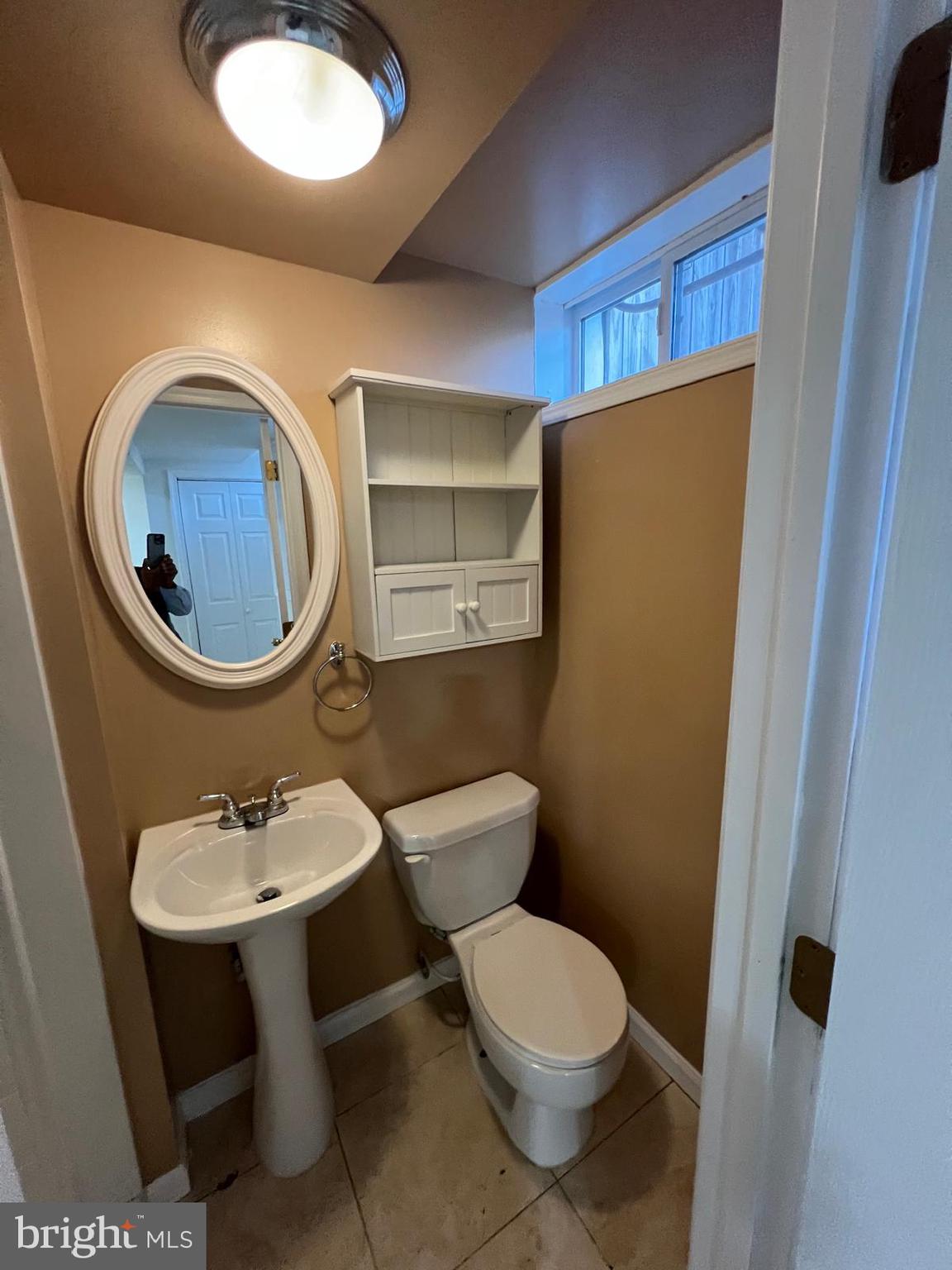 603 Braeside Road Baltimore, MD 21229 - Photo 26 of 30 a bathroom with a sink and a mirror