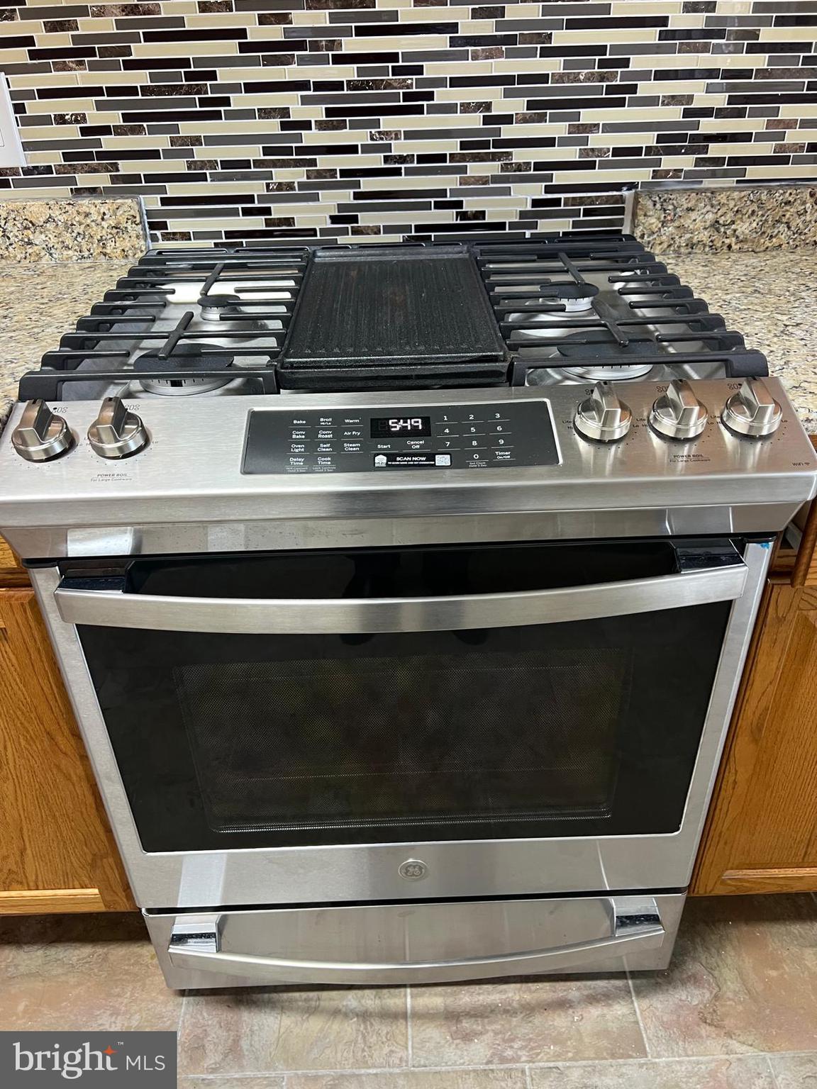 603 Braeside Road Baltimore, MD 21229 - Photo 5 of 30 a stove top oven sitting inside of a kitchen