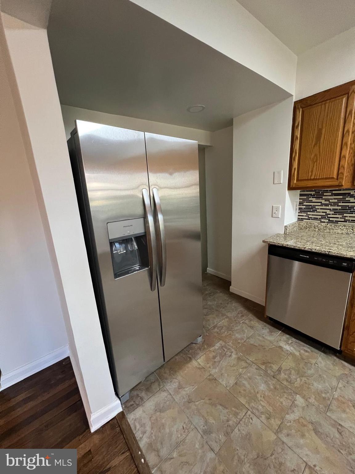 603 Braeside Road Baltimore, MD 21229 - Photo 9 of 30 a view of a refrigerator in kitchen and an empty room