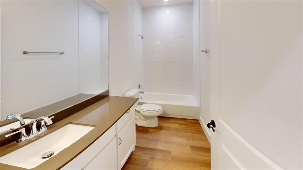 313 Buck Ridge Drive Frisco, TX 75068 - Photo 16 of 20 Full bathroom featuring a single vanity with a flat-panel cabinet, integrated sink, and an extended countertop