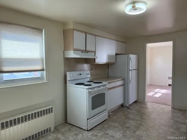 a kitchen with a stove and a refrigerator