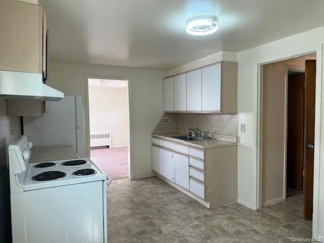 a kitchen that has a sink and a stove