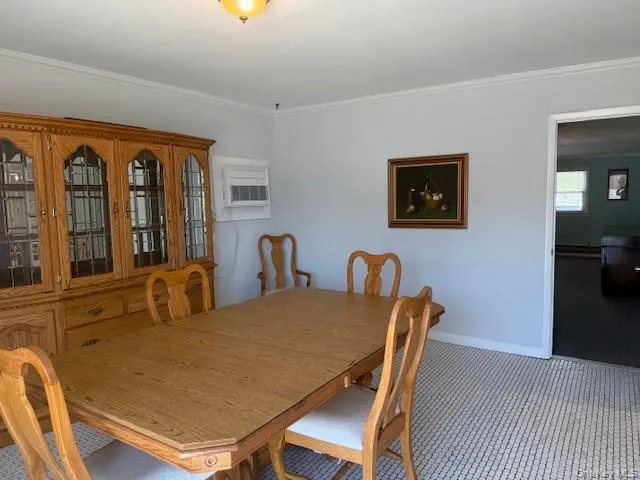 a dining room with furniture and window