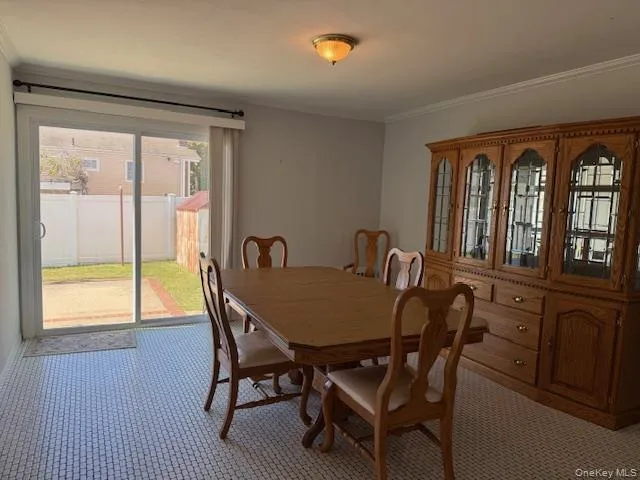 a view of a dining room with furniture large windows and wooden floor
