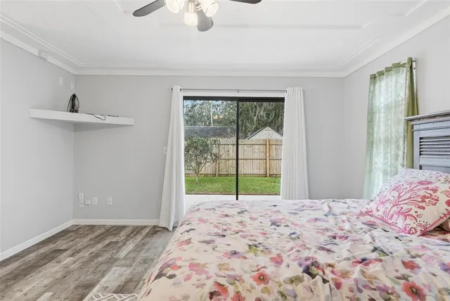 a view of a house with a backyard and a tree