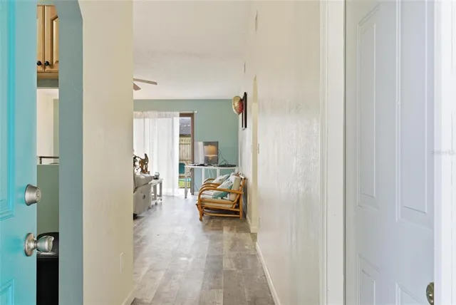 a view of a room with furniture and wooden floor