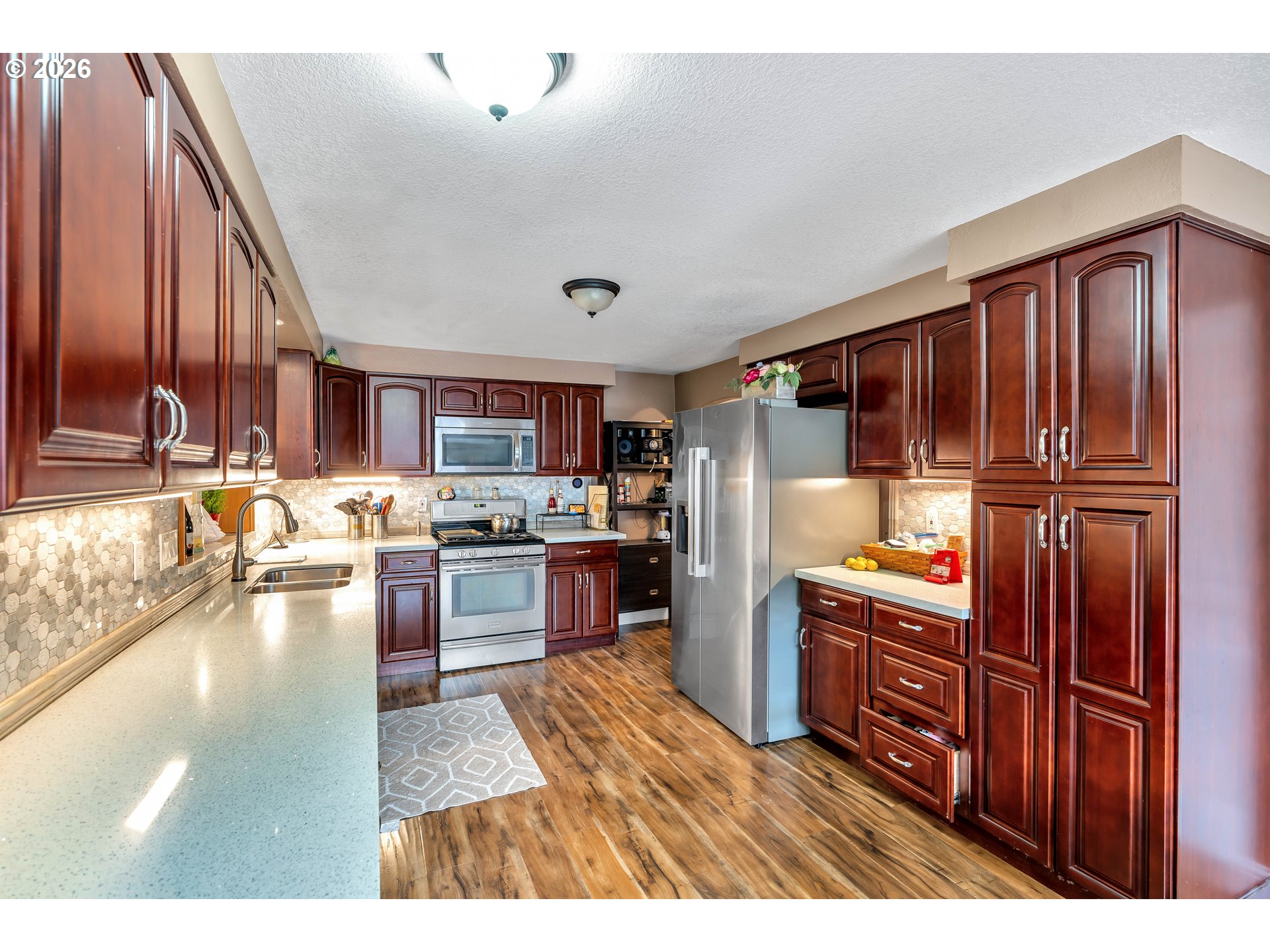 21498 Southwest Jay Street Beaverton, OR 97003 - Photo 16 of 47 a kitchen with stainless steel appliances granite countertop a refrigerator oven a sink dishwasher and wooden cabinets with large window