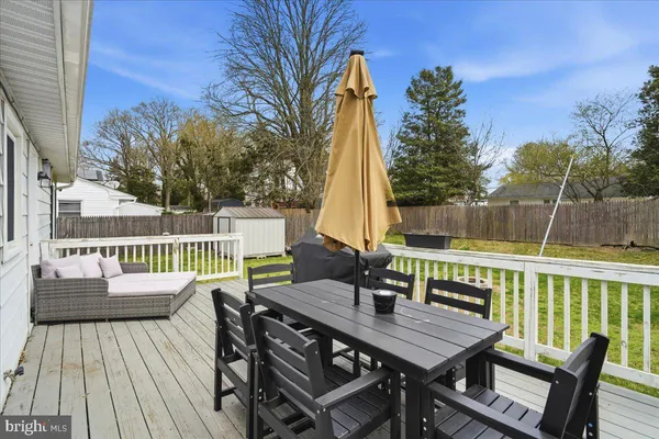 a view of a deck with furniture and trees