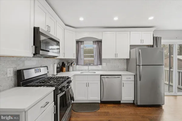 a kitchen with a sink stove and refrigerator
