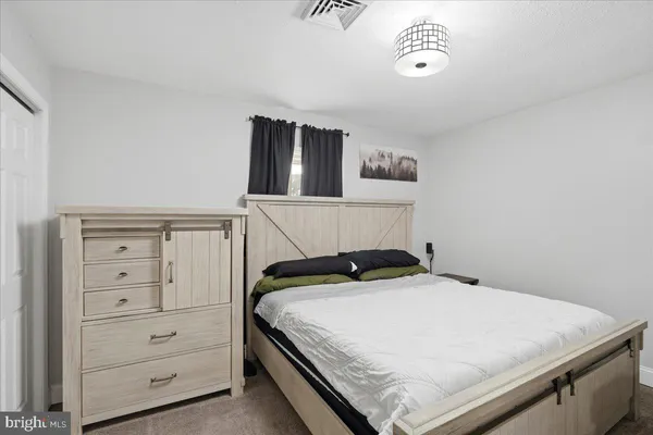 a bedroom with a bed and cabinet