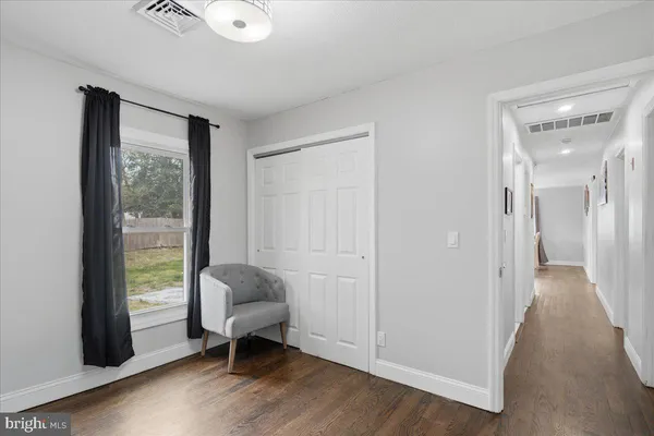 a view of a livingroom with wooden floor and a window