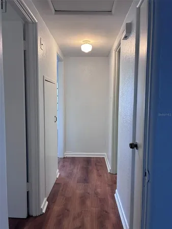 a view of a hallway with wooden floor