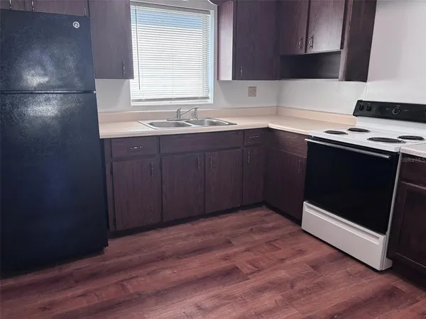 a kitchen with a sink stove and cabinets