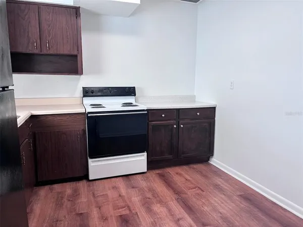 a kitchen with wooden cabinets and white appliances