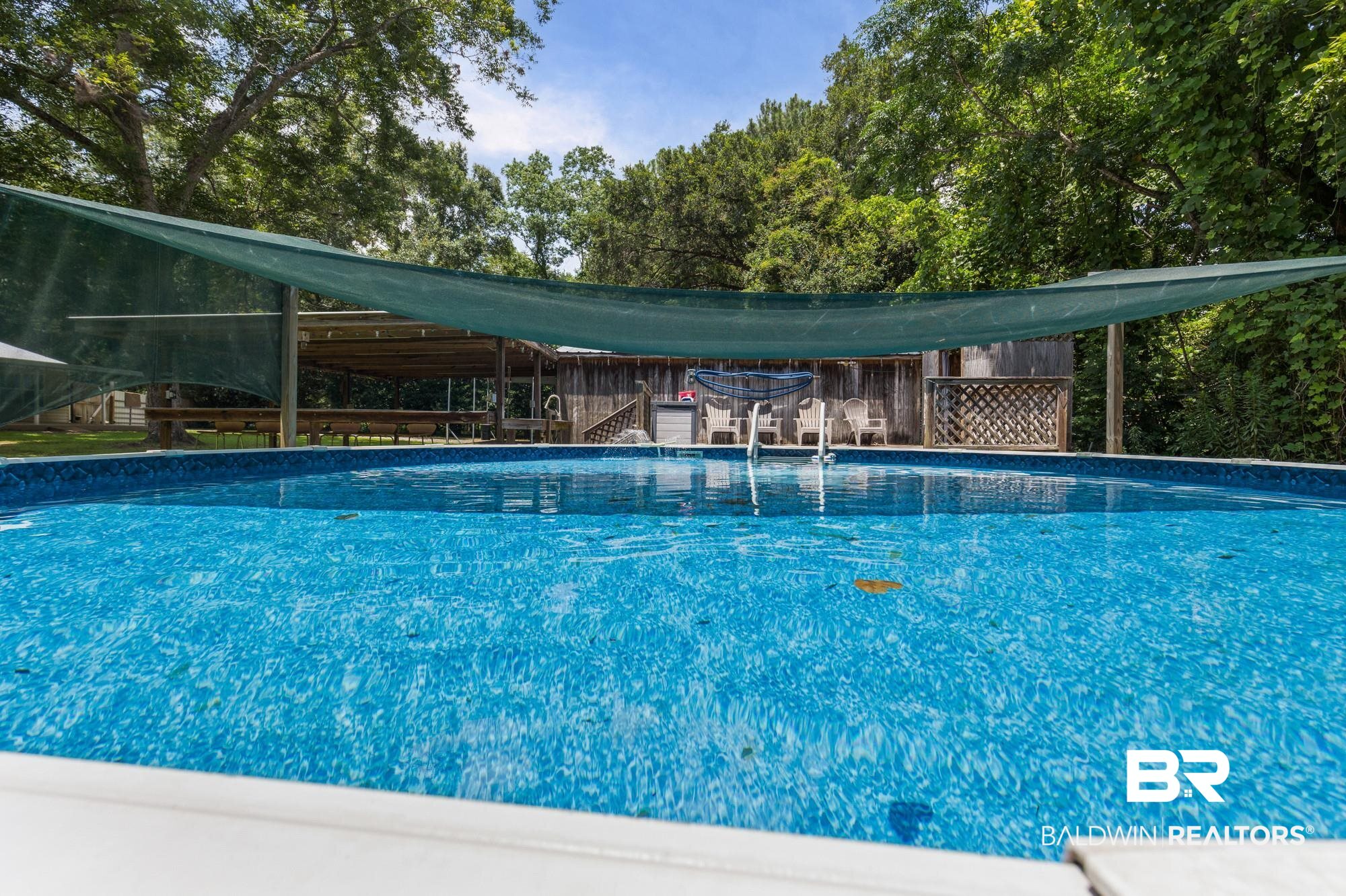 6933 Burbank Court Mobile, AL 36619 - Photo 4 of 25 In-ground swimming pool featuring a patterned blue liner and white coping