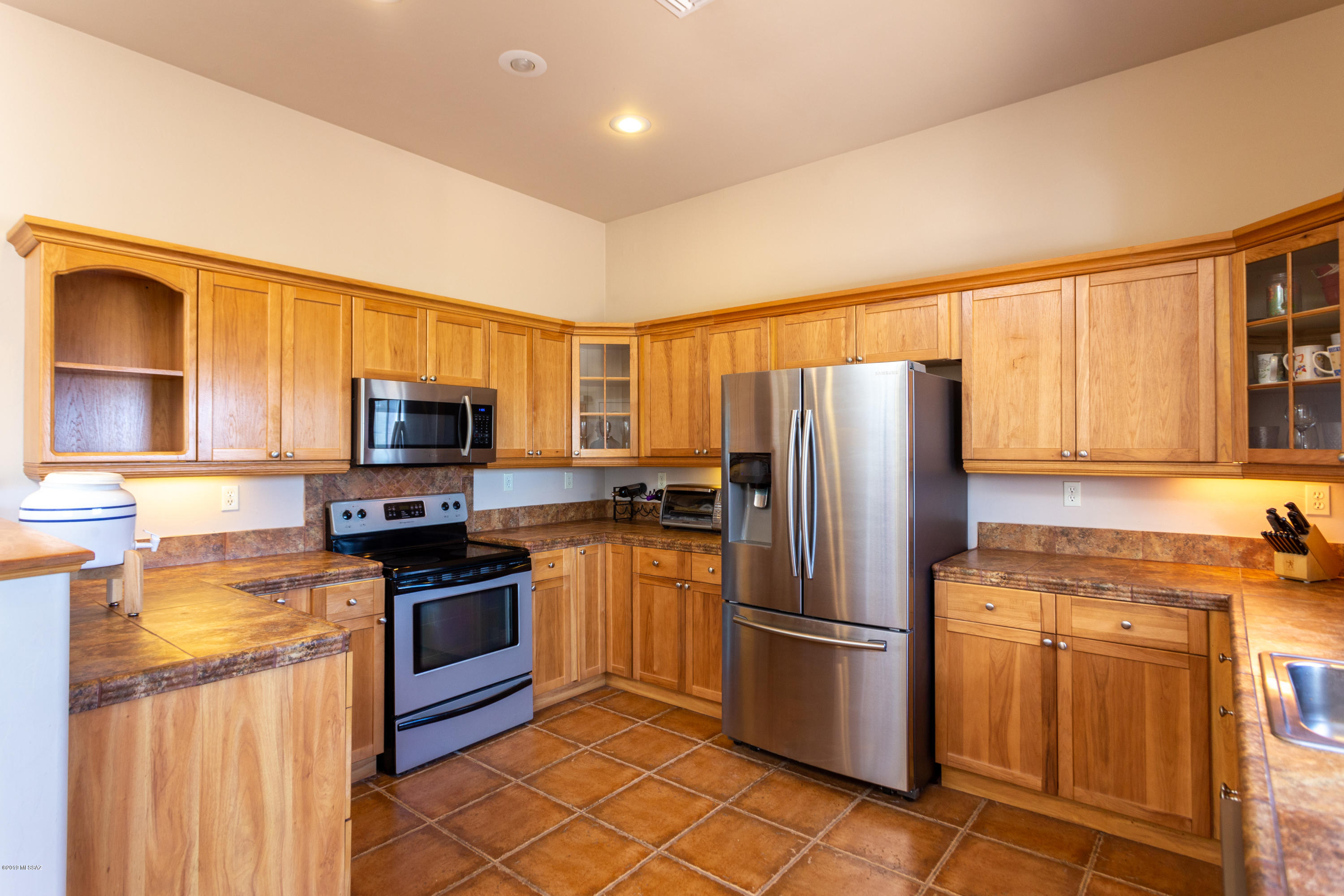 1748 Avenida Pastor Rio Rico, AZ 85648 - Photo 10 of 28 a kitchen with stainless steel appliances granite countertop a refrigerator stove microwave and sink