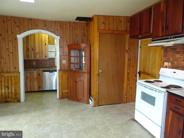 a view of a kitchen with refrigerator and cabinet