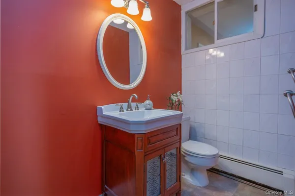 a bathroom with a sink a toilet and a mirror