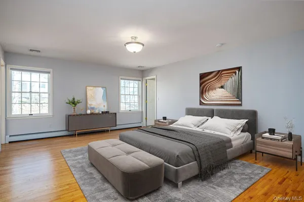 a spacious bedroom with a bed and a couch