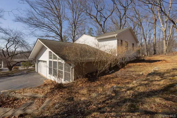 a view of a house with a yard covered in snow