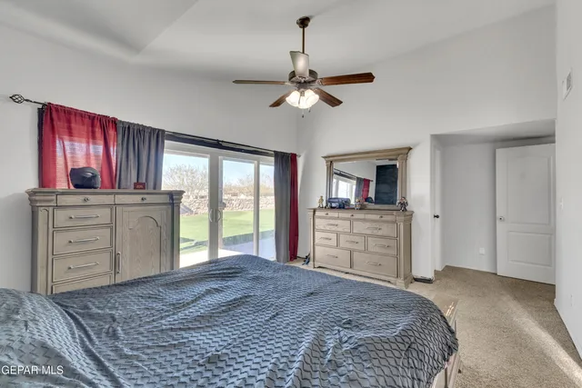 a bedroom with a large bed and a chandelier