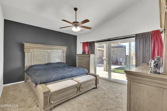 a bedroom with a bed and a television