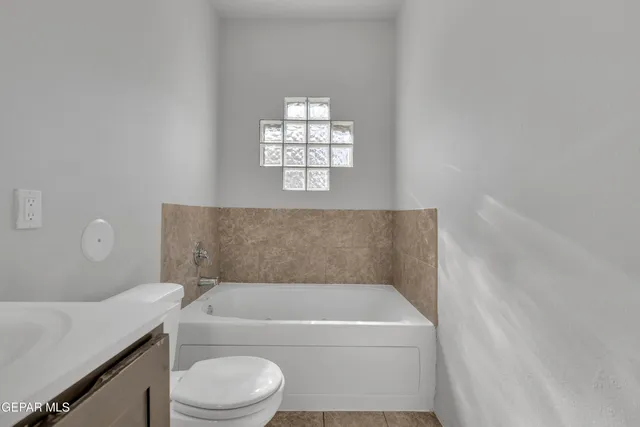 a bathroom with a bathtub and window