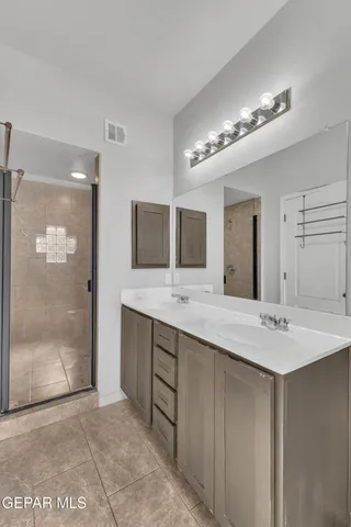 a bathroom with a double vanity sink mirror and double