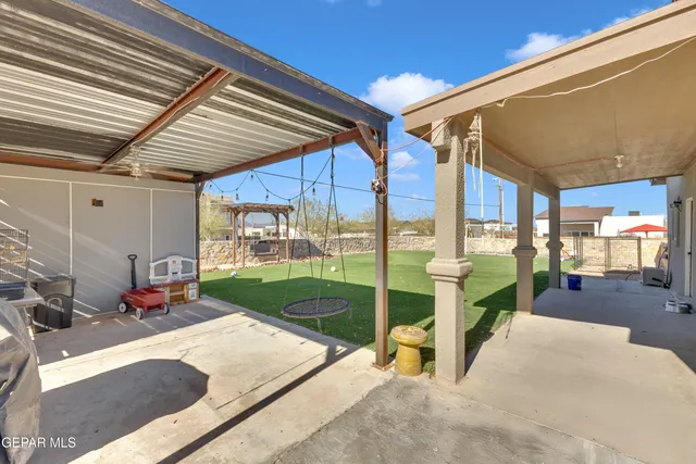 a view of patio with a table and chairs and potted plants