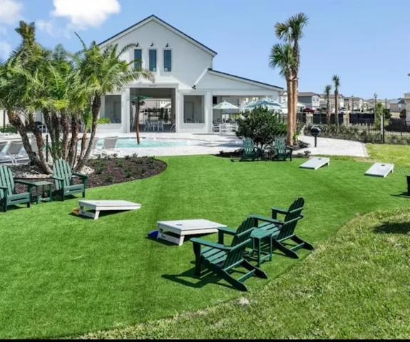 a view of a house with backyard sitting area and garden